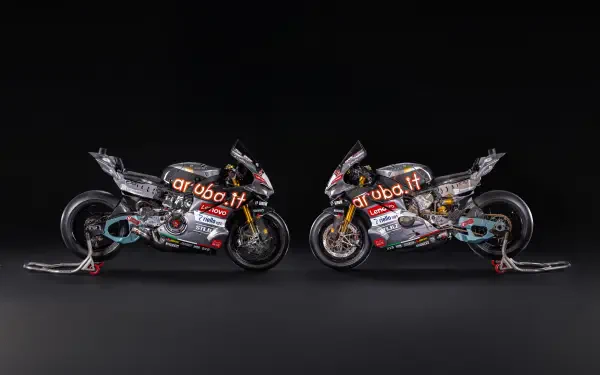 Ducati Panigale V4 R racing motorcycles facing each other against a dark background, 8K Ultra HD desktop wallpaper.