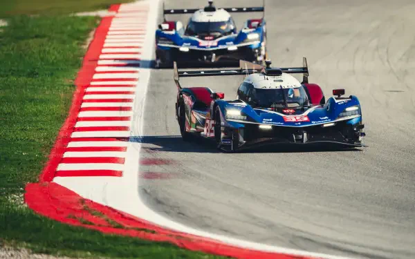 Alpine A424 race cars speeding along a race track, captured in a 5K Ultra HD desktop wallpaper.