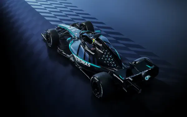 Mercedes-AMG Petronas F1 W17 race car speeding across a dark track, 4K Ultra HD desktop wallpaper.