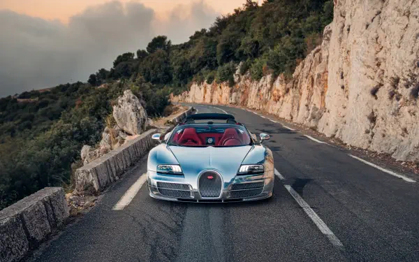 Bugatti Veyron Grand Sport Vitesse on a winding mountain road, featured in a 5K Ultra HD PC desktop wallpaper.