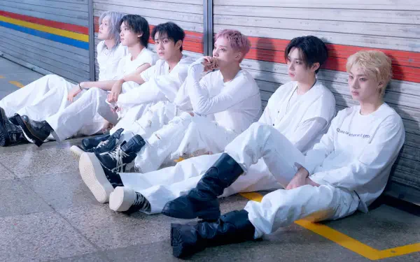 P1Harmony boy band members in white outfits seated by a colorful wall, featured in BLOW UP 4K Ultra HD PC desktop wallpaper.