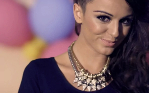 Cher Lloyd smiles confidently in a vibrant scene adorned with colorful balloons, capturing her musical essence in this HD desktop wallpaper background.