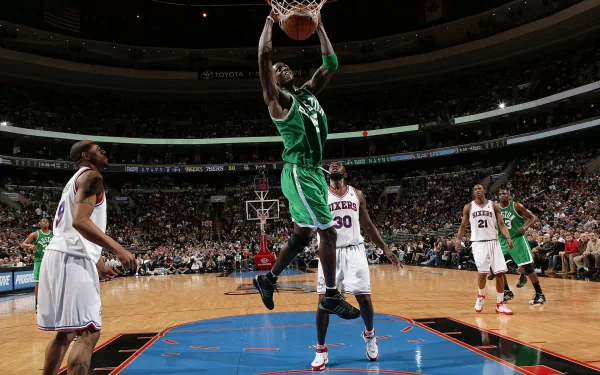 Kevin Garnett of the Boston Celtics jumps for a slam dunk during a basketball game in an HD sports wallpaper background.