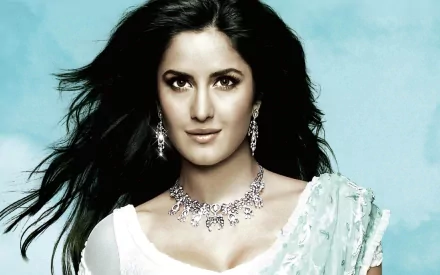 A stunning HD desktop wallpaper featuring Indian actress Katrina Kaif, showcasing her beauty with flowing hair, elegant jewelry, and a graceful outfit against a serene background.