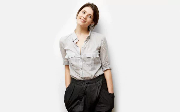 Gemma Arterton smiles in a stylish outfit, showcasing her effortless charm in this HD desktop wallpaper and background image.