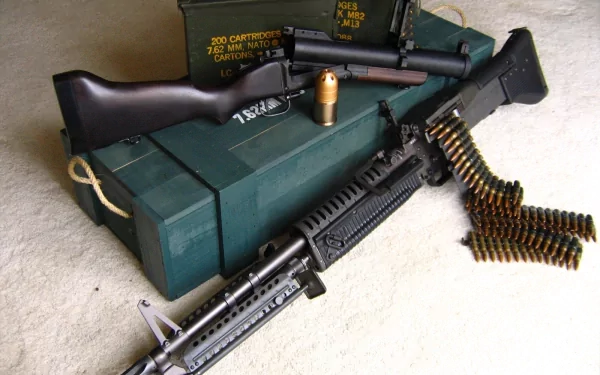 A close-up of an assault rifle and ammunition resting on a green military ammo box, captured in high definition for a PC desktop wallpaper and background.