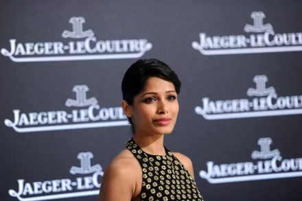 Freida Pinto, an actress with black hair, poses elegantly against a stylish backdrop featuring Jaeger-LeCoultre branding, captured in stunning 4K Ultra HD.