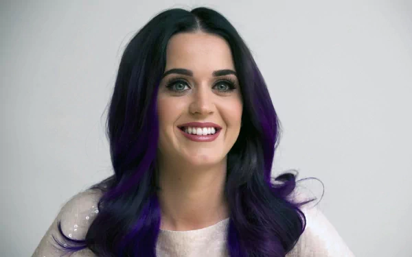 HD desktop wallpaper featuring Katy Perry with a vibrant smile and striking purple highlights in her hair, embodying the essence of music and charisma.