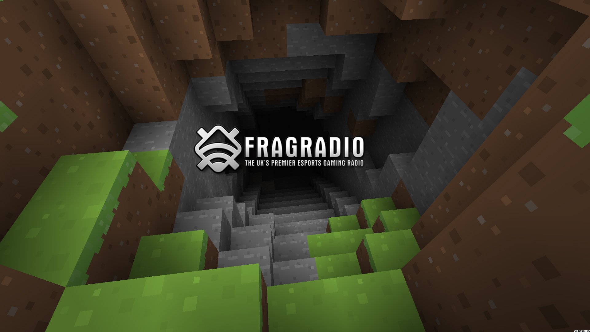 HD PC desktop wallpaper featuring a Minecraft cave entrance with pixelated grass and stone blocks, tagged as video game and Minecraft.