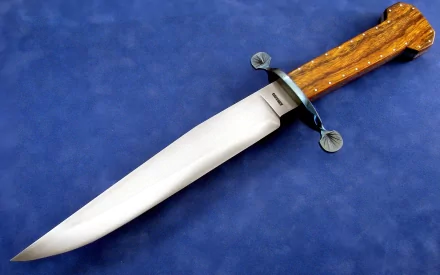 A high-definition desktop wallpaper featuring a man-made knife with a polished blade and intricately designed wooden handle, set against a blue background.
