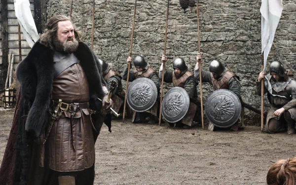 Mark Addy as Robert Baratheon in Game of Thrones stands confidently before soldiers with shields and spears in this HD PC desktop wallpaper.