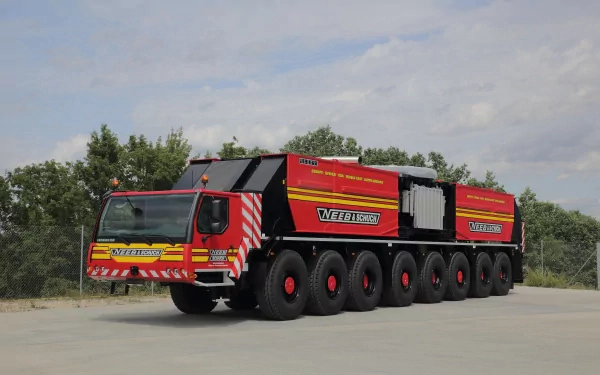 4K Ultra HD desktop wallpaper featuring a large Liebherr heavy-duty vehicle with multiple wheels, set against a cloudy sky and green trees background.