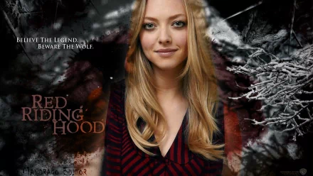 HD PC desktop wallpaper of a blonde celebrity actress smiling against a snowy, dark Red Riding Hood–themed background.
