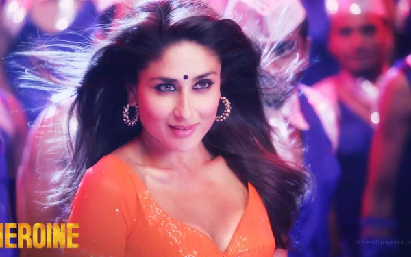 HD desktop wallpaper featuring celebrity Kareena Kapoor in an orange outfit, with a focused and captivating expression, set against a vibrant background.