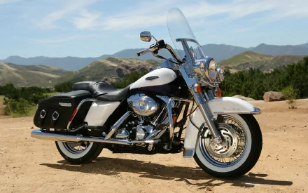 A stunning Harley-Davidson Road King motorcycle parked against a scenic landscape, showcasing its classic design and powerful presence. Perfect HD wallpaper for bike enthusiasts.
