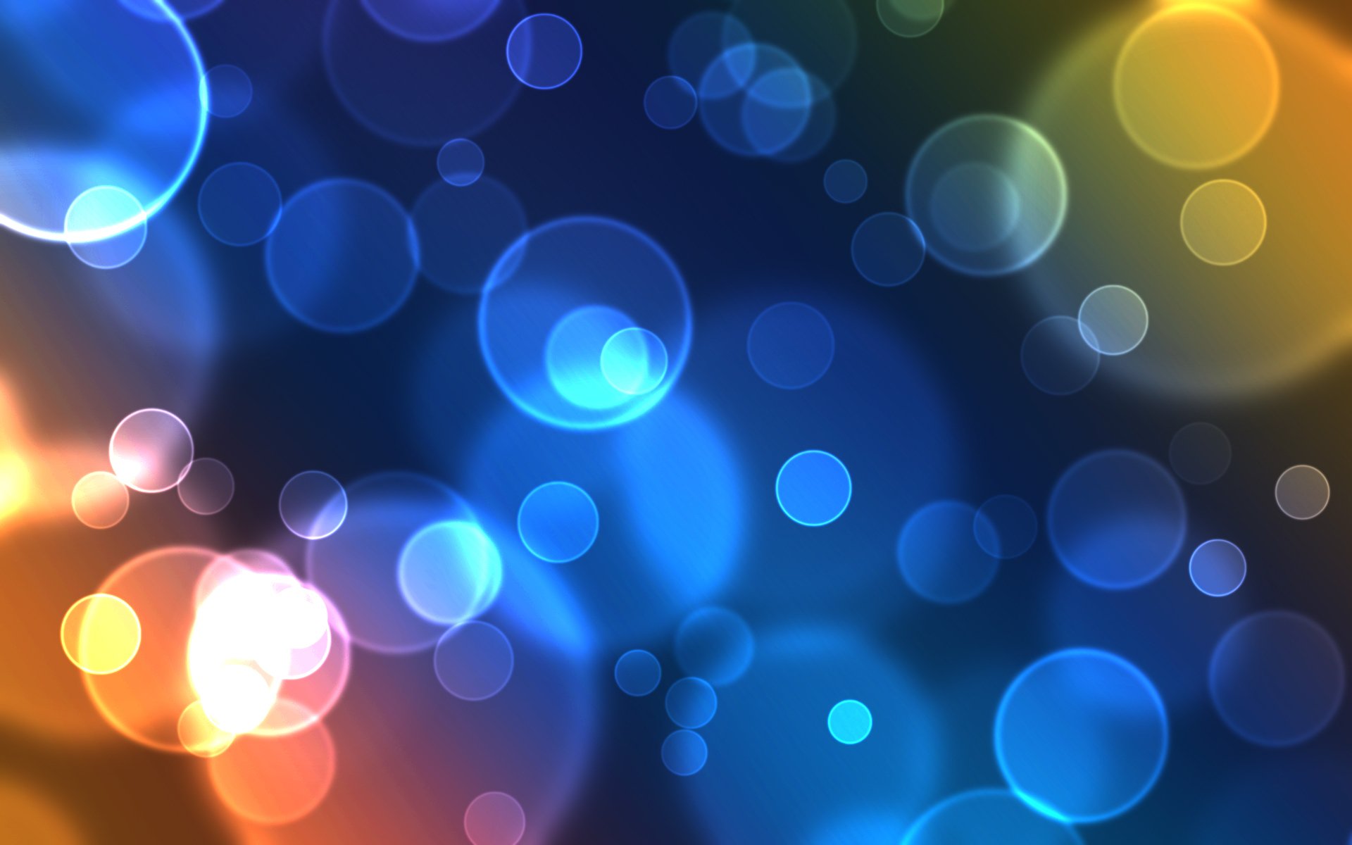 HD PC desktop wallpaper featuring an abstract design of glowing, overlapping circles in blue, orange, and purple hues creating a vibrant, dynamic background.