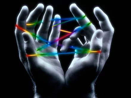 An abstract image featuring two hands intertwining with vibrant colored lines against a dark background, creating a cool and captivating HD wallpaper for your desktop.