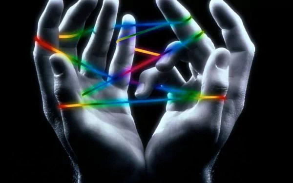 An abstract image featuring two hands intertwining with vibrant colored lines against a dark background, creating a cool and captivating HD wallpaper for your desktop.