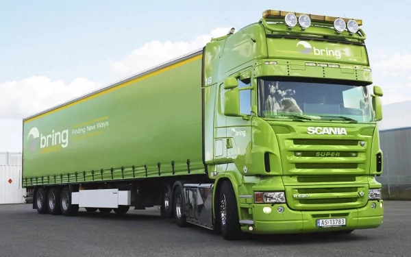 A striking green Scania truck with a refrigerated trailer, showcasing a sleek design. This HD image serves as a vibrant desktop wallpaper and background.