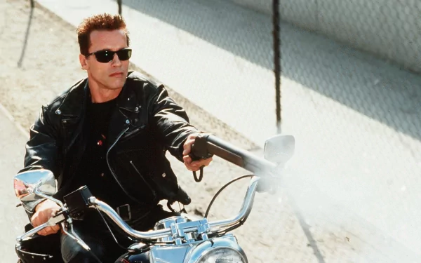 Arnold Schwarzenegger, as the Terminator, rides a motorcycle in a dynamic scene from Terminator 2: Judgment Day, showcasing an iconic moment from the film. High-definition wallpaper.
