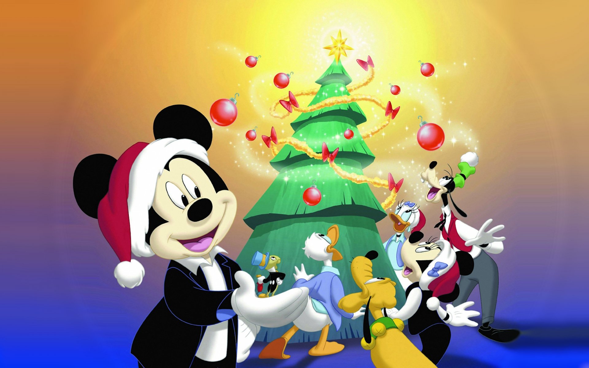 A festive scene featuring Mickey Mouse, Minnie Mouse, Donald Duck, Daisy Duck, Goofy, and Jiminy Cricket around a decorated Christmas tree, celebrating the holiday spirit.