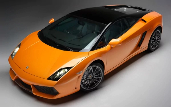 HD desktop wallpaper featuring a sleek yellow Lamborghini Gallardo sports car against a dark gray background.