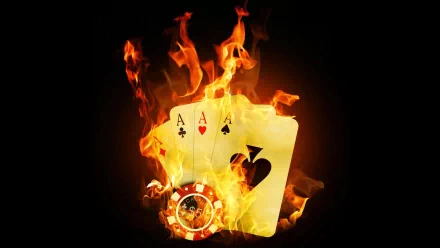 A striking HD desktop wallpaper featuring flaming playing cards and a poker chip, embodying the intensity of a high-stakes poker game. A captivating visual for enthusiasts.