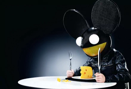 HD PC desktop wallpaper featuring Deadmau5's signature mouse helmet, holding a fork and knife, ready to eat a wedge of cheese on a white table against a dark background.