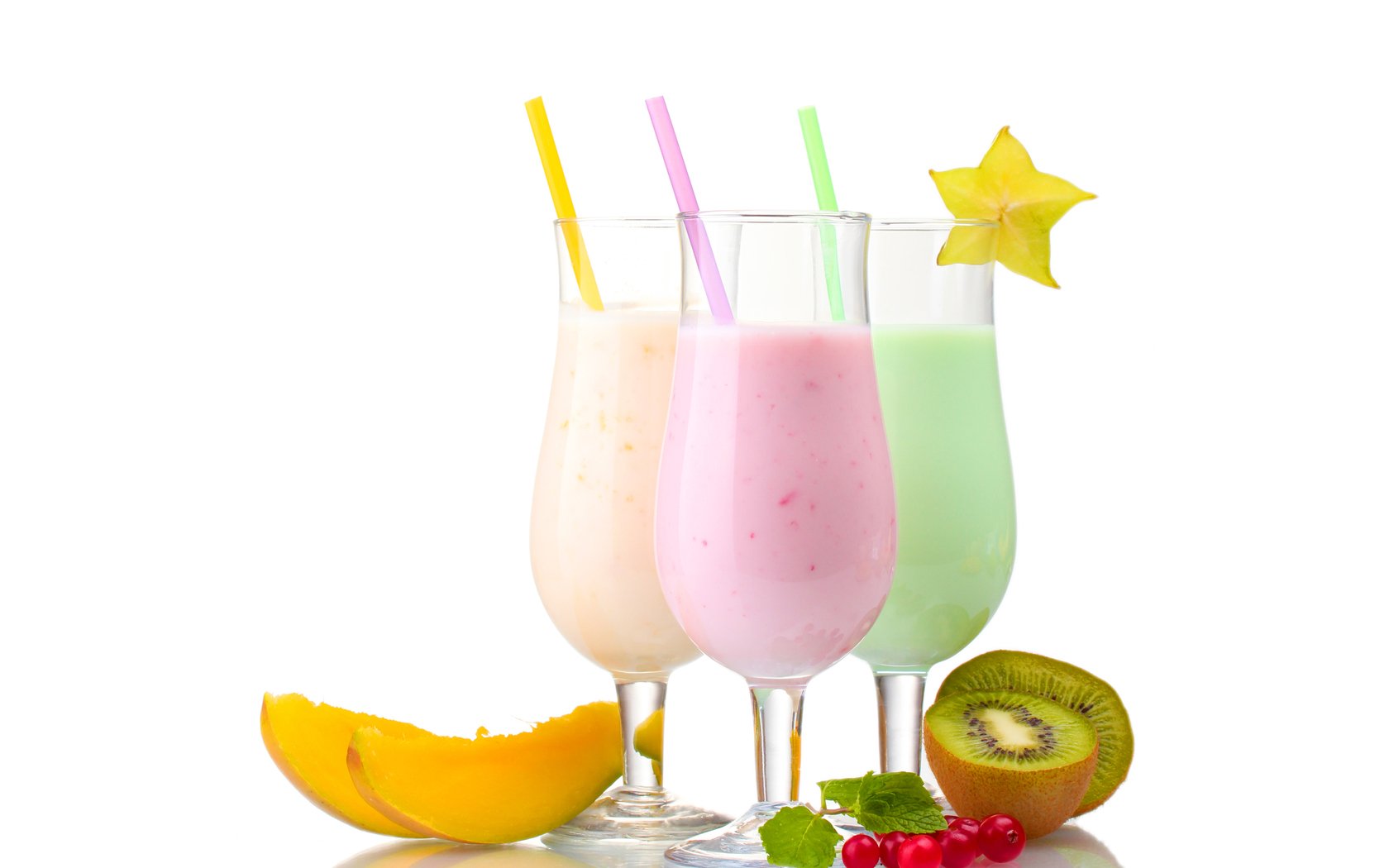 HD PC desktop wallpaper featuring three colorful creamy drinks with straws, accompanied by fresh fruit slices including starfruit, kiwi, and melon.