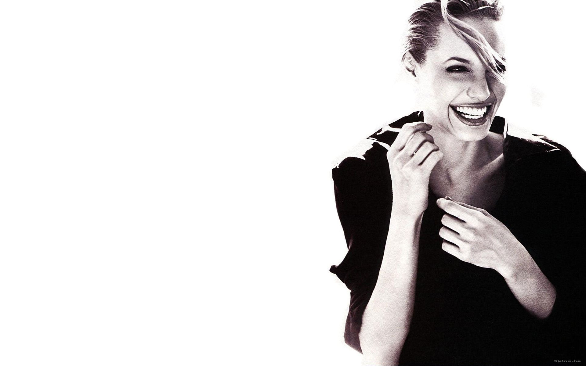 HD PC desktop wallpaper featuring a black-and-white portrait of celebrity Angelina Jolie smiling against a clean white background.