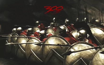 HD PC desktop wallpaper featuring a dramatic battle scene from the movie 300, showcasing Spartan warriors with shields and spears in formation.