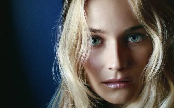 A close-up of Diane Kruger, featuring her striking blue eyes and softly tousled blonde hair, set against a dark background. This image serves as a high-definition PC desktop wallpaper.