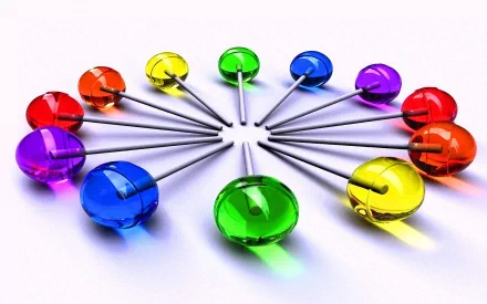 Artistic 3D HD desktop wallpaper featuring a vibrant ring of glossy, colorful push pins arranged in a circular pattern on a white background.