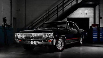 HD PC desktop wallpaper featuring a sleek black Chevrolet Chevelle SS parked in a dimly lit garage with industrial stairs in the background.