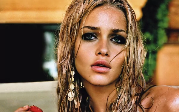 HD desktop wallpaper featuring a close-up of a woman with wet hair and striking eyes, showcasing Ana Beatriz Barros in a natural, sunlit setting.