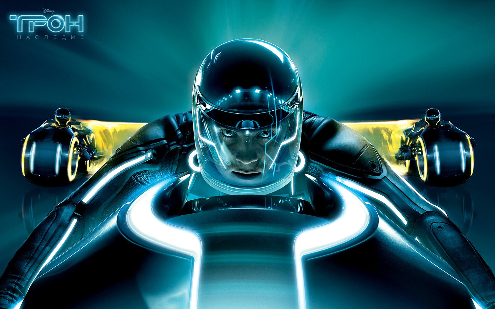 HD PC desktop wallpaper from the movie TRON: Legacy showing a glowing light-cycle rider in a sleek helmet charging toward the viewer on a neon-blue futuristic background