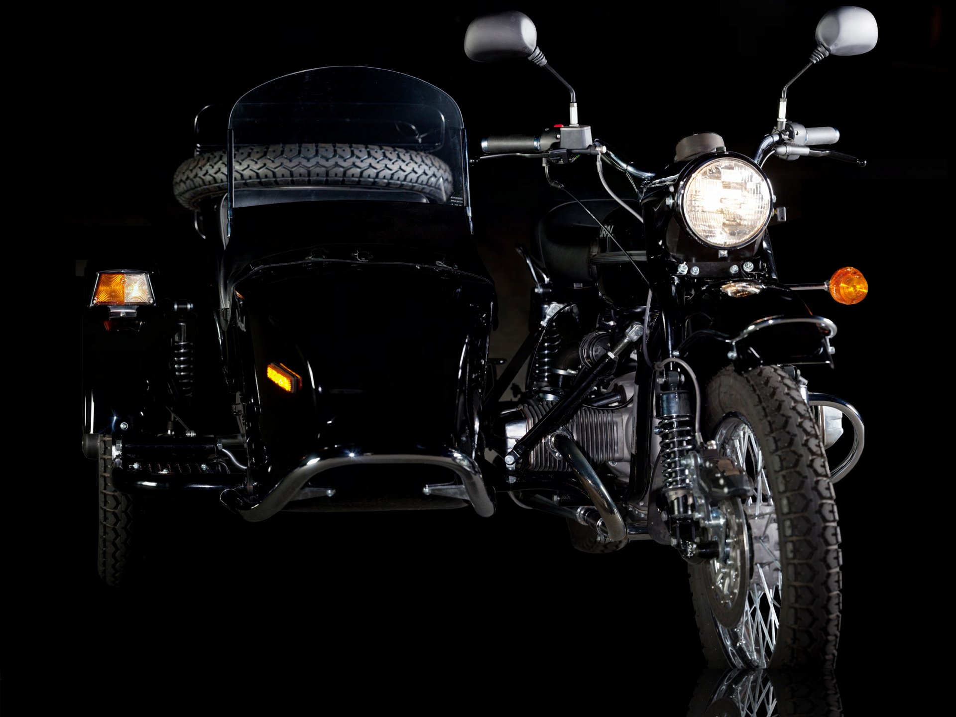 HD desktop wallpaper of a black Russian Ural motorcycle with sidecar, set against a dark background highlighting the vehicle's details.
