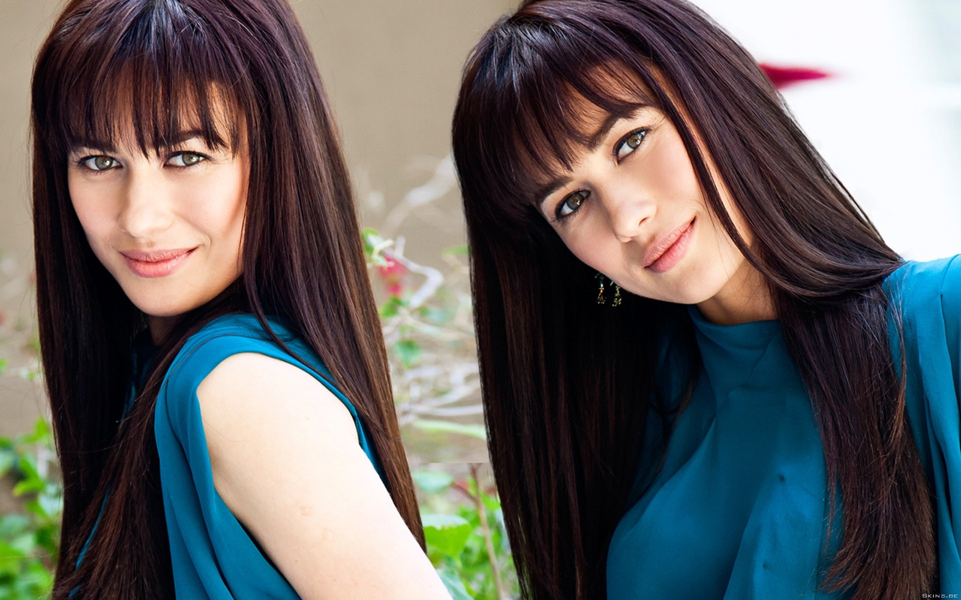 A stunning HD desktop wallpaper featuring celebrity Olga Kurylenko, showcasing her elegant style and captivating smile against a lush backdrop.