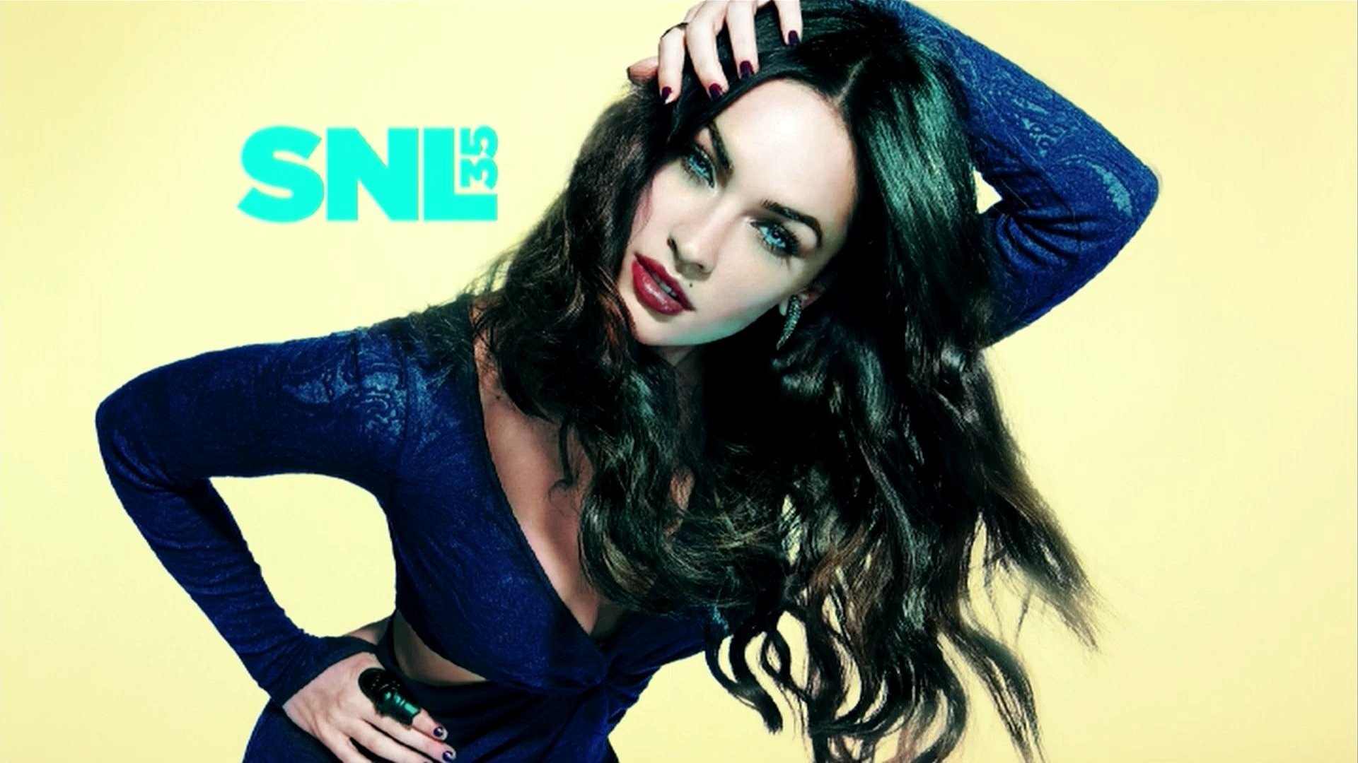 Megan Fox poses confidently against a vibrant yellow background in this HD wallpaper, showcasing her striking features and sleek hairstyle, with SNL 35 prominently displayed.