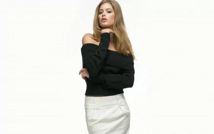 A high-definition desktop wallpaper featuring celebrity Doutzen Kroes in a stylish off-shoulder black sweater and a light skirt, posing elegantly against a plain background.