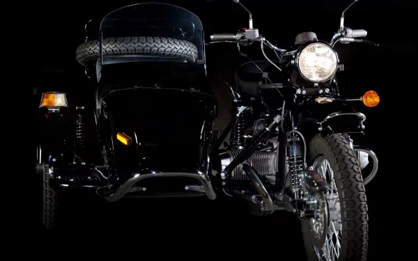 HD desktop wallpaper of a black Russian Ural motorcycle with sidecar, set against a dark background highlighting the vehicle's details.
