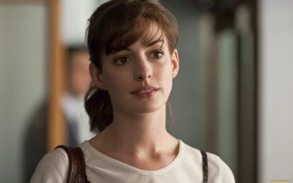 Anne Hathaway gazes thoughtfully in this HD desktop wallpaper, capturing her elegant presence in a candid moment. A stylish background for any fan of the celebrity.