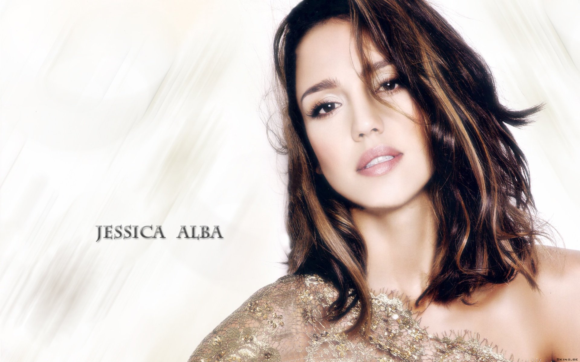 HD desktop wallpaper featuring celebrity Jessica Alba, showcasing her elegant look with a soft background and sophisticated styling.