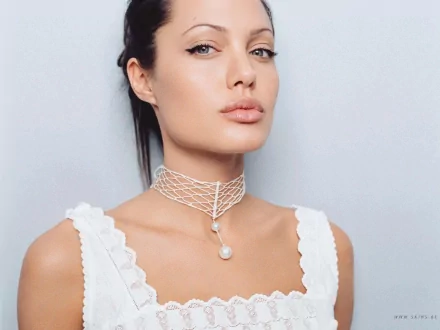 HD PC desktop wallpaper featuring a close-up portrait of celebrity Angelina Jolie wearing a white top and a delicate pearl necklace against a light background.