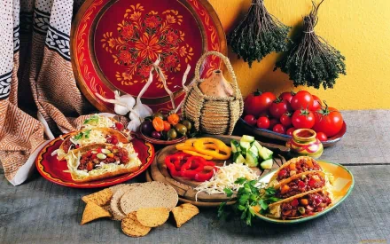 HD PC desktop wallpaper featuring a colorful food meal with tacos, fresh vegetables, herbs, and traditional Mexican tableware arranged on a rustic wooden surface.