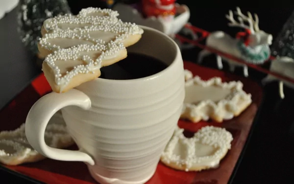 HD PC desktop wallpaper featuring a white mug with a Christmas tree-shaped cookie topped with white sprinkles, alongside festive sweets on a red and black background.