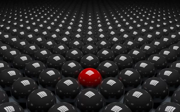 A striking abstract CGI design featuring a sea of grey spheres with a prominent red ball at the center, creating a bold visual contrast in a 3D wallpaper background.