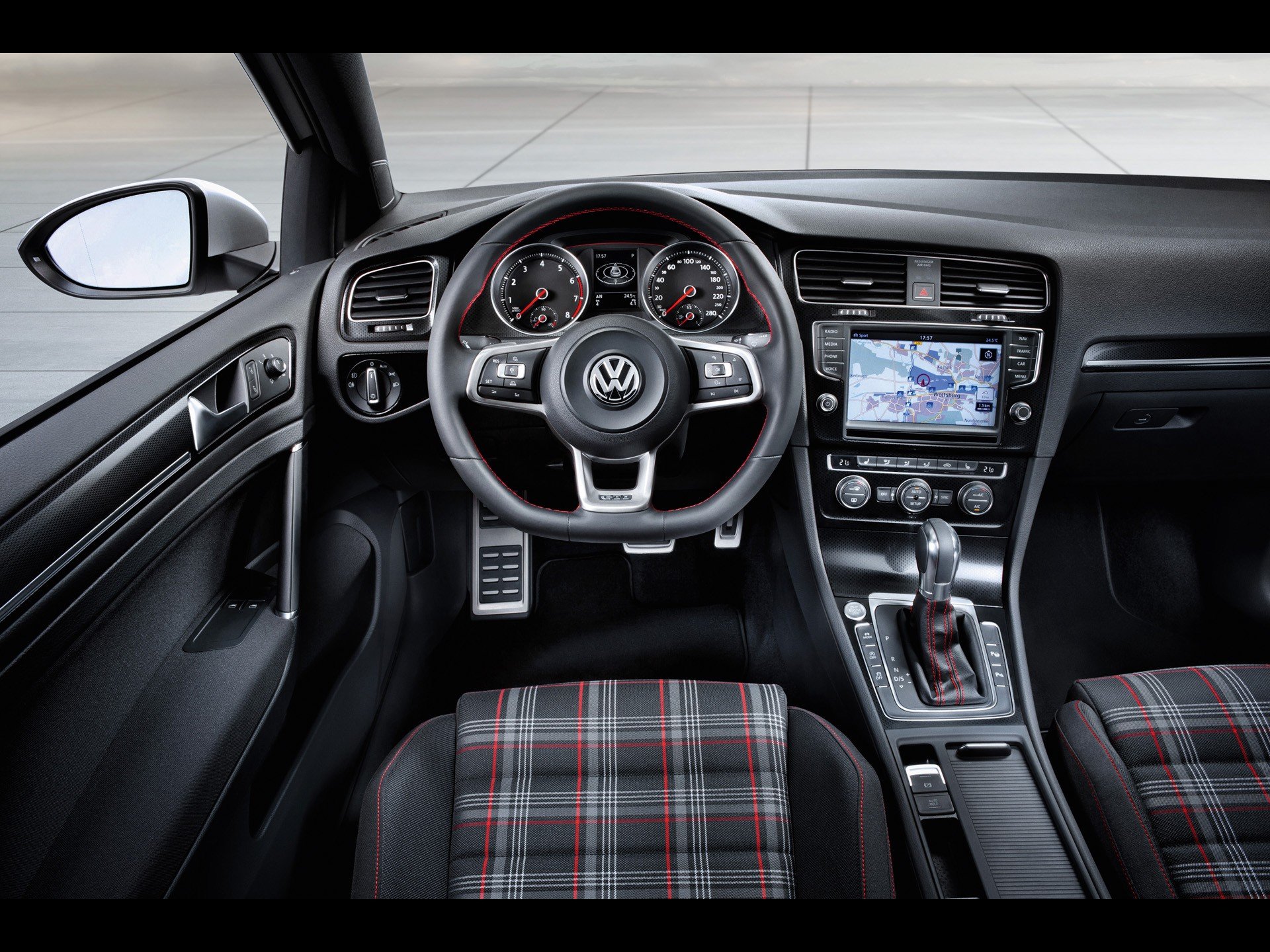 HD PC desktop wallpaper showcasing the interior of a Volkswagen vehicle, featuring a detailed view of the steering wheel, dashboard, and plaid-patterned seats.
