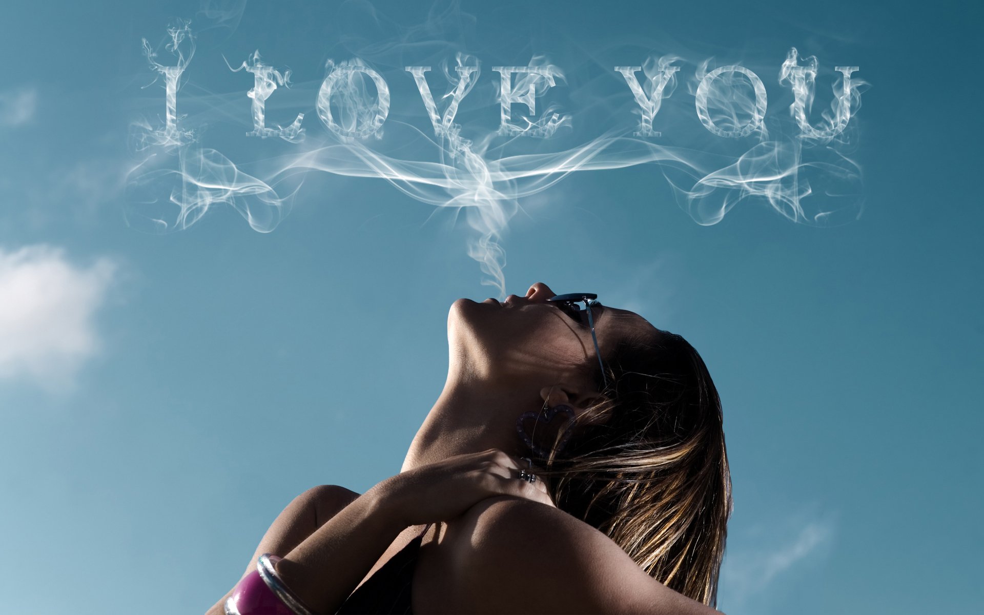 HD artistic desktop wallpaper with a woman exhaling smoke that forms the words I LOVE YOU against a clear blue sky backdrop, capturing a theme of love.