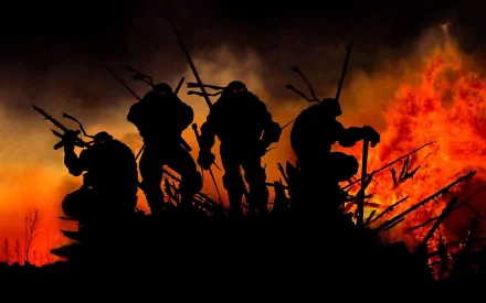 Silhouetted Teenage Mutant Ninja Turtles stand ready amidst fiery chaos in a dramatic 4K Ultra HD comic-style desktop wallpaper.